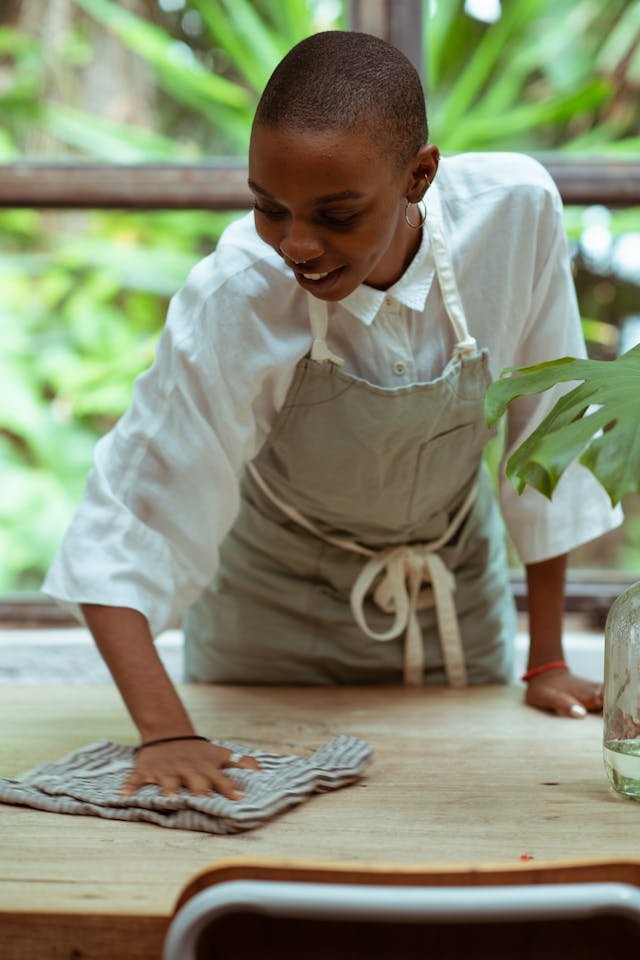 woman cleaning table